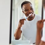 oral health goals, man brushing his teeth