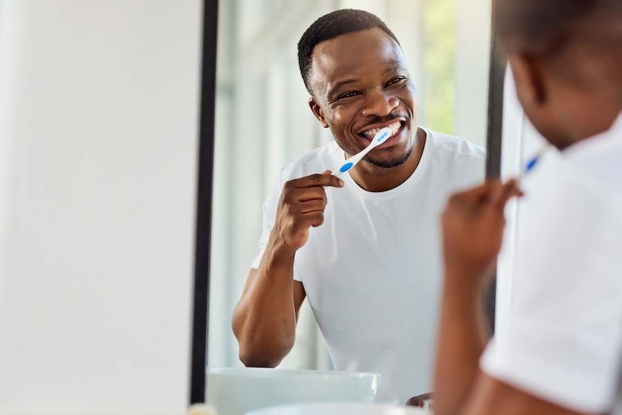 oral health goals, man brushing his teeth