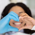 dentist and patient making a heart with their hands, dental hygiene habits