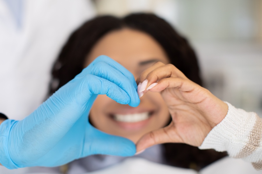 dentist and patient making a heart with their hands, dental hygiene habits